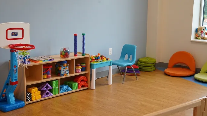 Dress-up clothes and dolls in the Kids Brigade room